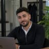 Amine Belkacem, tech founder working on laptop in modern office